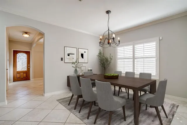 a view of a dining room with furniture and chandelier