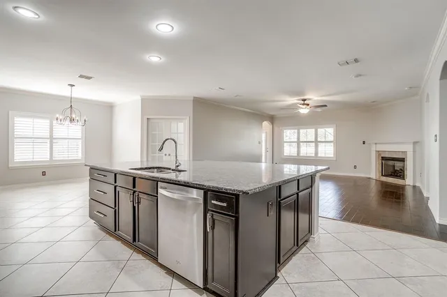 a kitchen with a stove a sink and a refrigerator