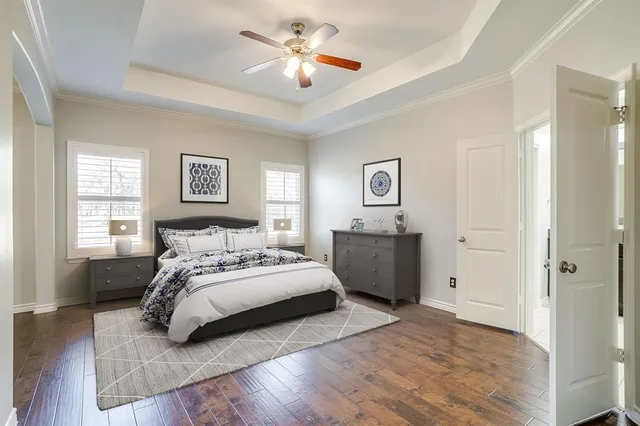 a spacious bedroom with a bed and a chandelier