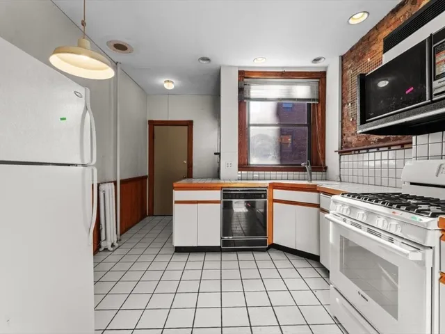 a kitchen with a stove a sink and a refrigerator