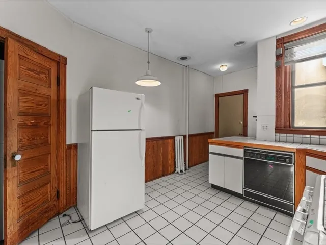 a kitchen with stainless steel appliances a refrigerator and a stove
