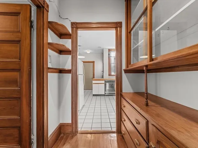 a view of a hallway with a large window and wooden floor