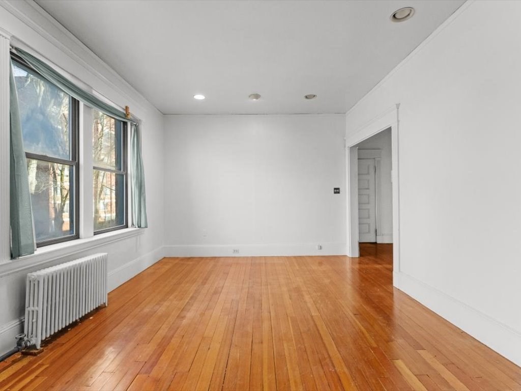 26 Beaufort Road, Unit 2 Boston, MA 02130 - Photo 7 of 34 a view of an empty room with wooden floor and a window