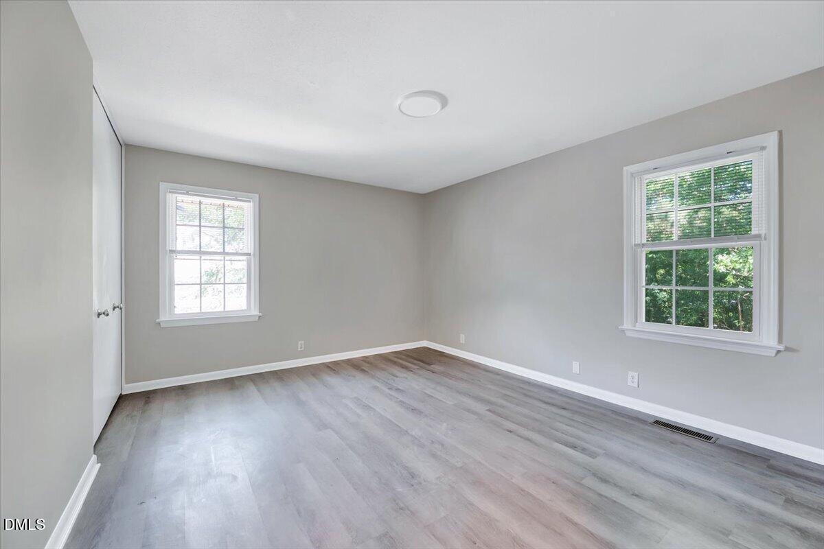 3408 Atlantic Avenue Raleigh, NC 27604 - Photo 35 of 48 an empty room with wooden floor and windows