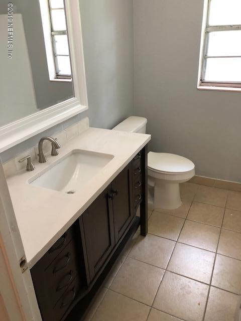 7408 Proxima Road Jacksonville, FL 32210 - Photo 8 of 10 a bathroom with a sink vanity and a toilet