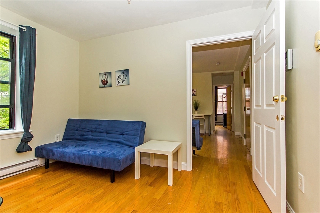 106 Tyler Street Boston, MA 02111 - Photo 11 of 16 a living room with furniture and a rug