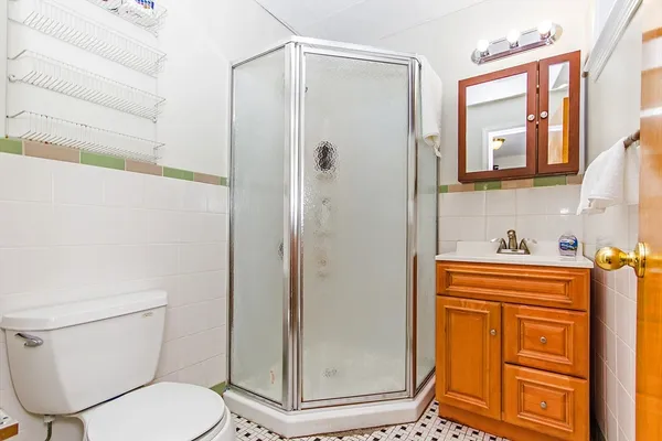 a bathroom with a toilet and a shower
