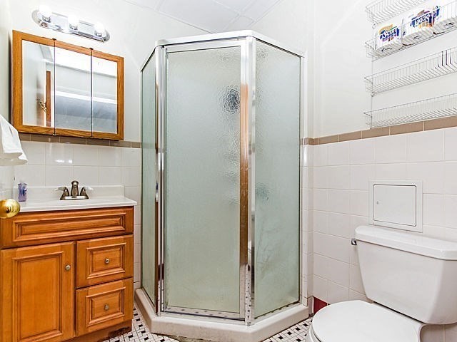 106 Tyler Street Boston, MA 02111 - Photo 7 of 16 a bathroom with a toilet a sink and shower