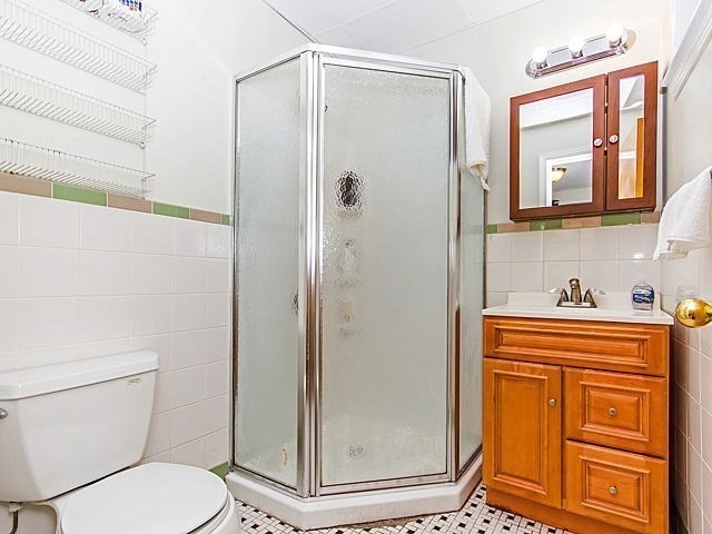 106 Tyler Street Boston, MA 02111 - Photo 8 of 16 a bathroom with a granite countertop toilet sink and shower