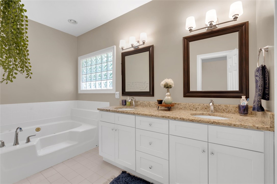 117 Winding Creek Road Anderson, SC 29621 - Photo 19 of 42 This bathroom features a double vanity and soaking tub, offering a serene personal retreat.