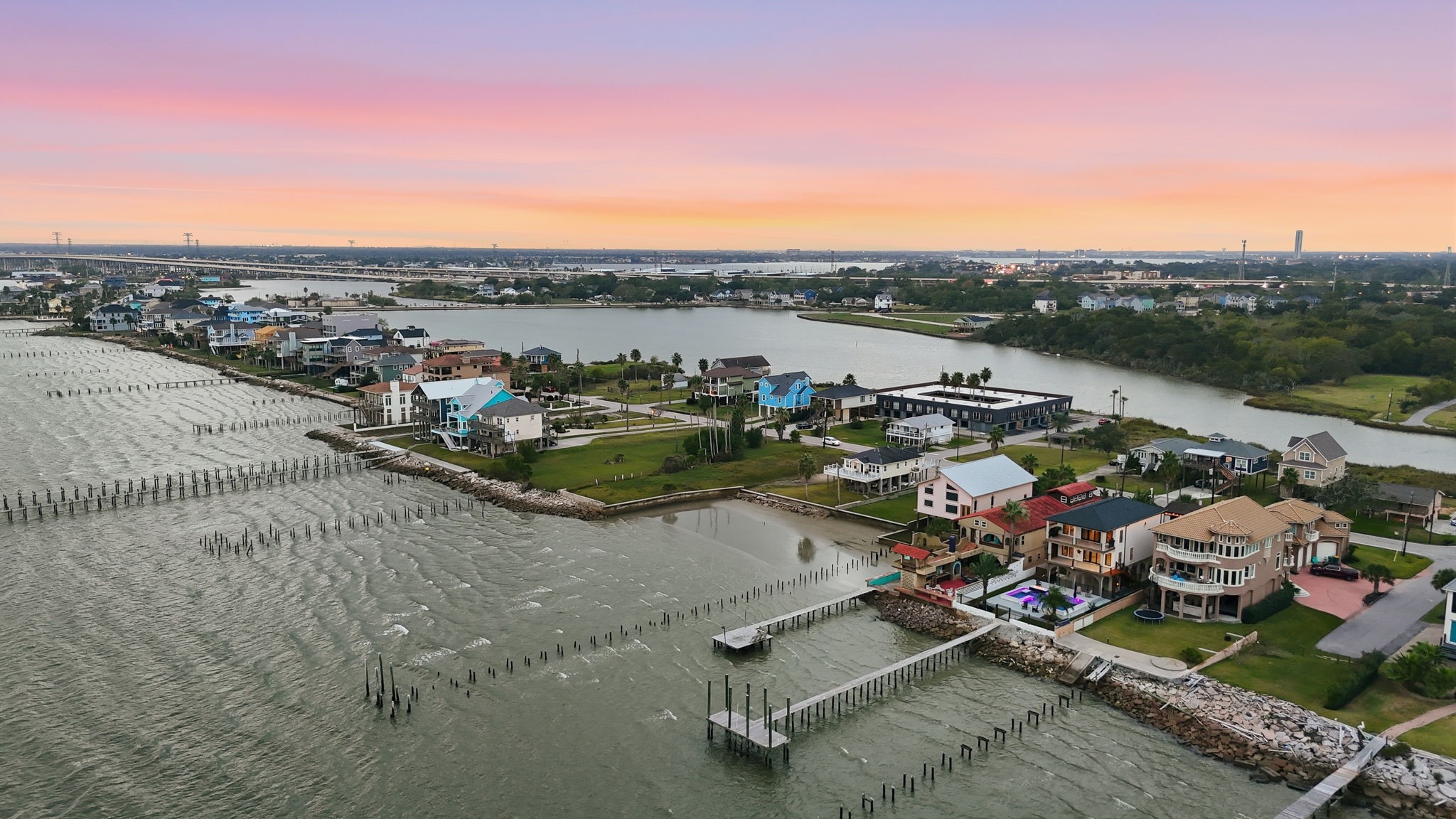 1918 Todville Road Seabrook, TX 77586 - Photo 40 of 41 Aerial view captures this modern bayfront home perfectly positioned on its oversized lot, with a private pier reaching into Galveston Bay. It’s a striking example of Seabrook’s coveted coastal lifestyle, where living in the heart of the Houston Bay Area means endless water views and sunsets on the horizon.