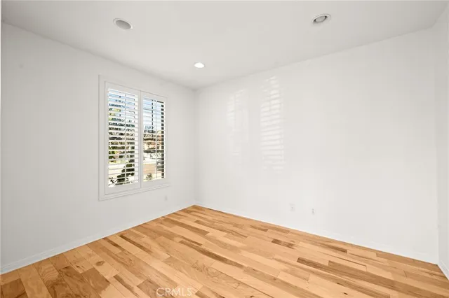 a bathroom with a granite countertop sink a toilet and a mirror