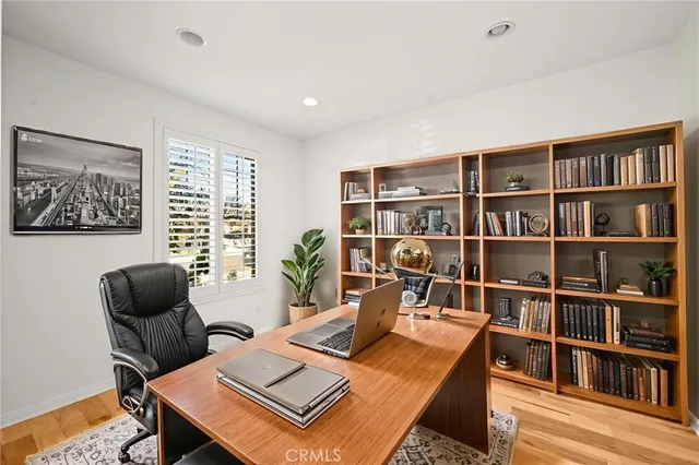 a kitchen with stainless steel appliances granite countertop a stove a sink dishwasher and a refrigerator with wooden floor