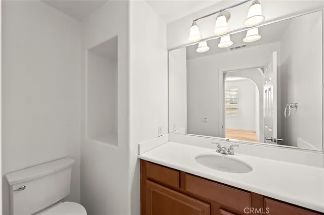 a large kitchen with granite countertop a large counter top stainless steel appliances and windows