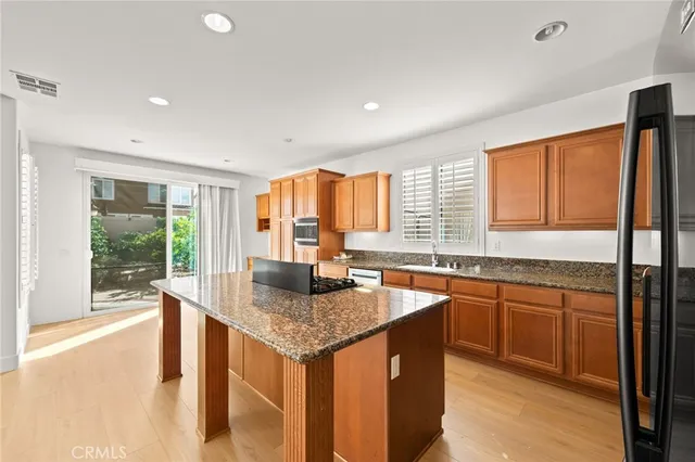 a kitchen with granite countertop a sink and a stove