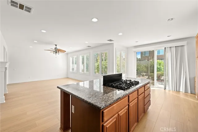 a view of empty room with a fireplace and windows