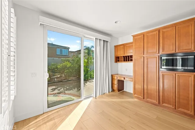a view of an empty room with a fireplace and a window