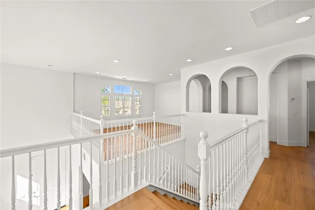 a view of a room with a ceiling fan and wooden floor