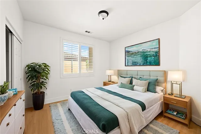 an aerial view of residential houses with a swimming pool and mountains