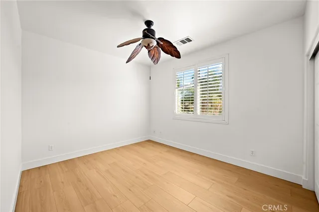 an aerial view of a city with lots of residential buildings and mountain view in back