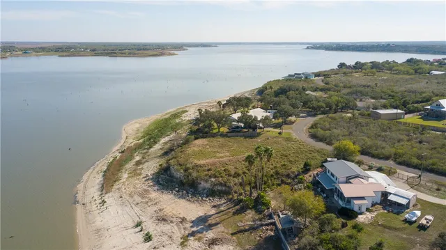 an aerial view of a house with a lake view