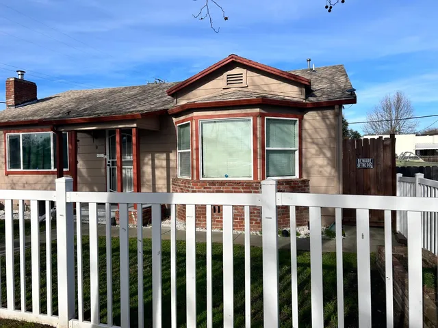 a front view of a house with wooden porch