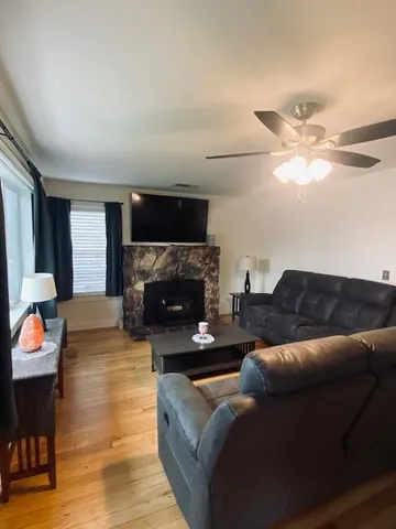 a living room with furniture a fireplace and a flat screen tv