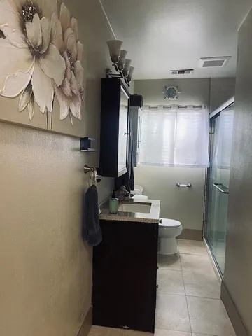 a bathroom with a sink toilet and mirror