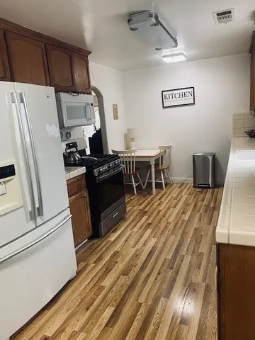 a kitchen with a refrigerator and a stove