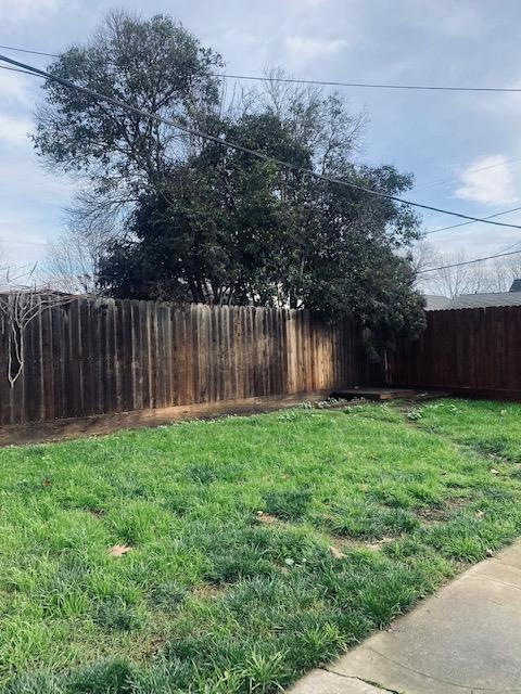 9 4th Avenue Isleton, CA 95641 - Photo 10 of 10 a view of a backyard with large trees and wooden fence