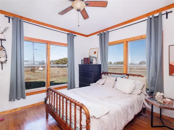 a bedroom with a balcony a bed and a chandelier
