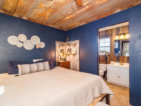 a bedroom with a large bed and a large window