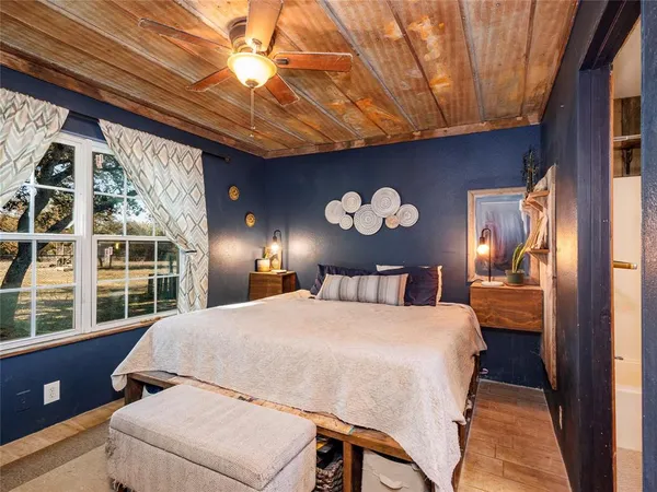 a bedroom with a bed and a chandelier