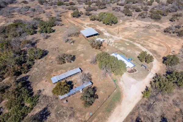 an aerial view of house with a yard