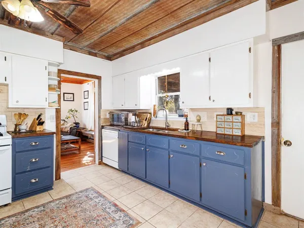 a large kitchen with stainless steel appliances granite countertop a sink and cabinets