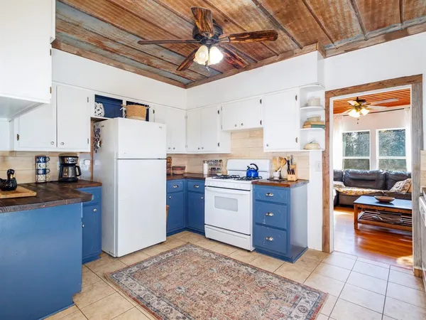 a kitchen with a refrigerator and a stove