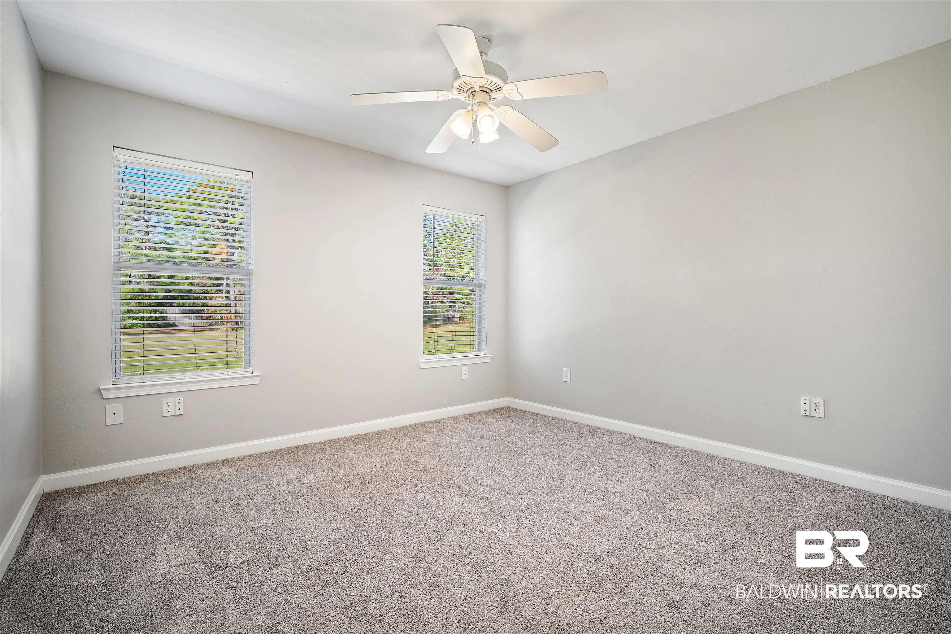 3010 Drag Strip Lane Coden, AL 36523 - Photo 26 of 44 Empty room featuring a wealth of natural light, ceiling fan, and carpet flooring