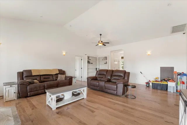 a kitchen with kitchen island granite countertop a sink a counter top space cabinets and stainless steel appliances
