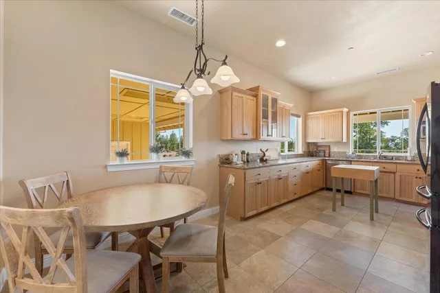 a room with lots of white furniture and wooden floor