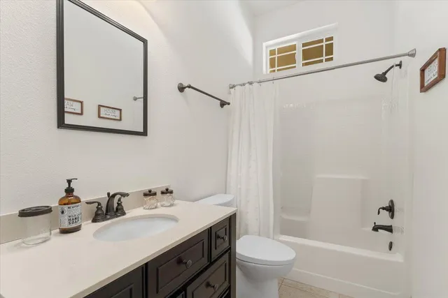 a white toilet sitting next to a bathroom sink