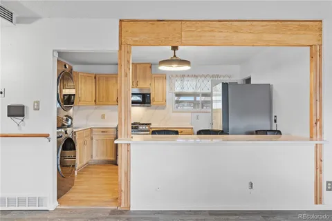 a kitchen with stainless steel appliances granite countertop a sink and a refrigerator