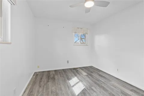 a view of a room with wooden floor and white walls