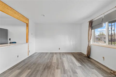 a view of wooden floor and windows in a room