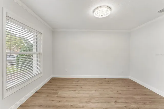 a view of a room with wooden floor and window