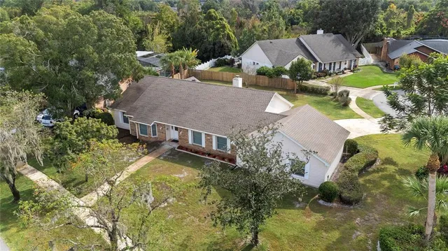 an aerial view of a house with swimming pool and garden