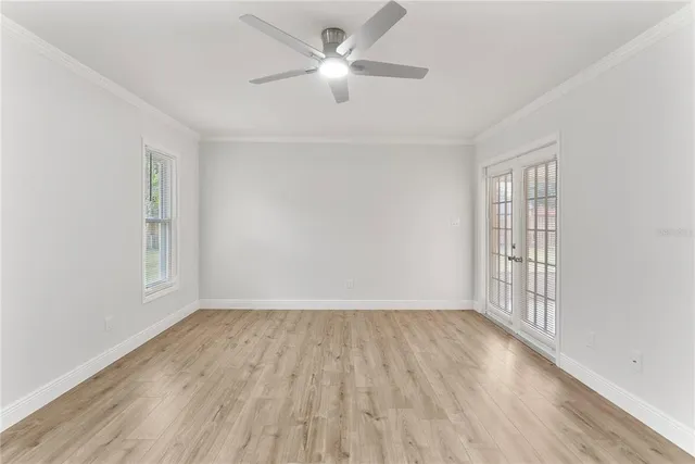 wooden floor in an empty room with a window