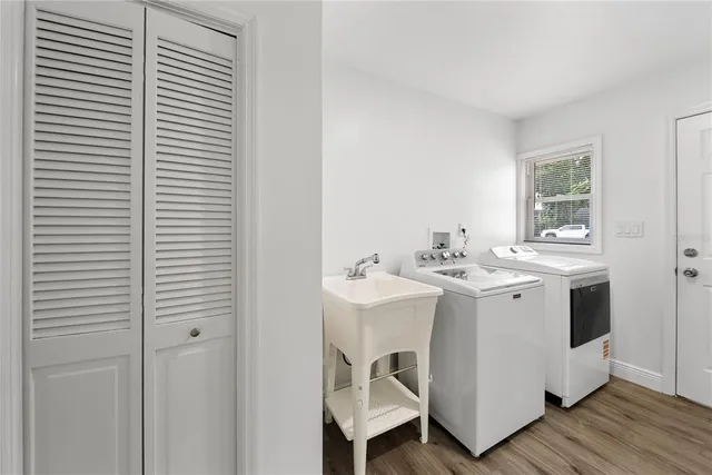 a view of a kitchen with a sink and wooden floor