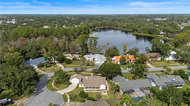 an aerial view of lake and residential houses with outdoor space