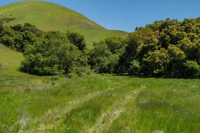 a view of a large mountain with mountains in the background