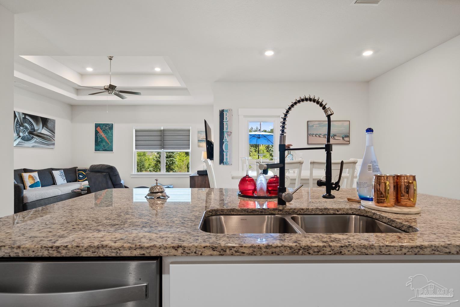 5773 Danbury Boulevard Pace, FL 32571 - Photo 13 of 34 a kitchen with sink a faucet and chandelier